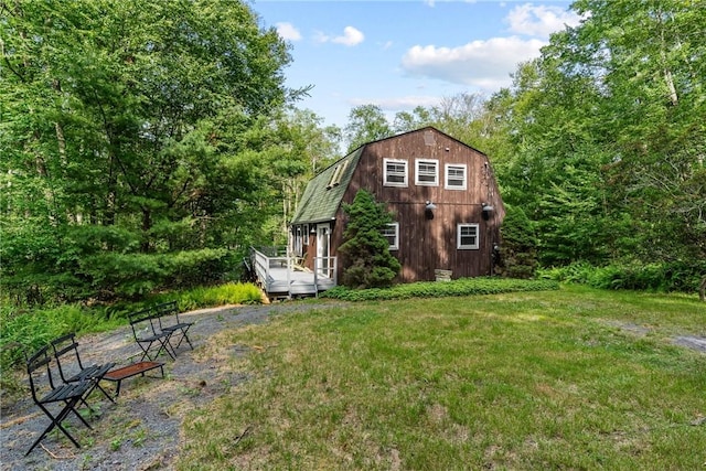 exterior space featuring a yard and a wooden deck