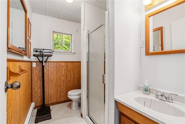 bathroom featuring vanity, baseboard heating, a shower with door, and wood walls