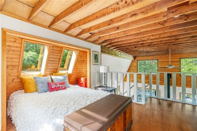 bedroom featuring vaulted ceiling with beams, dark hardwood / wood-style floors, multiple windows, and wooden walls