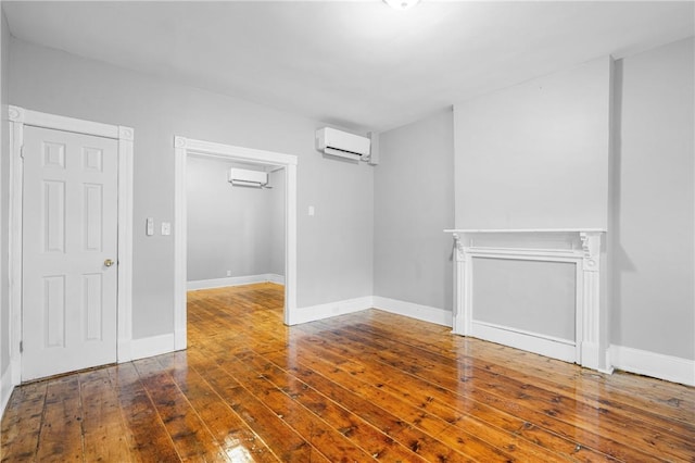 interior space featuring dark wood-type flooring and a wall mounted air conditioner