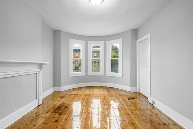 unfurnished room with wood-type flooring