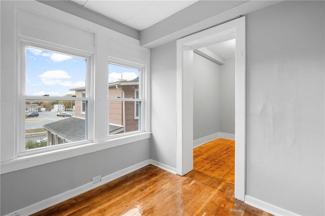 empty room with hardwood / wood-style flooring