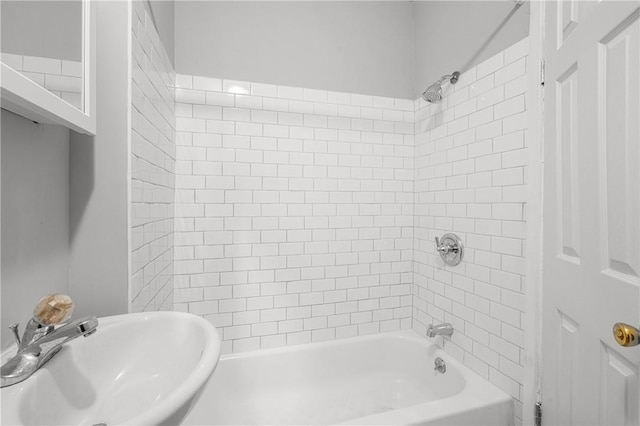 bathroom featuring tiled shower / bath and sink