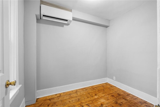 walk in closet with hardwood / wood-style floors and a wall mounted air conditioner