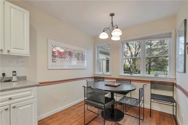 dining area with a chandelier and light wood-type flooring