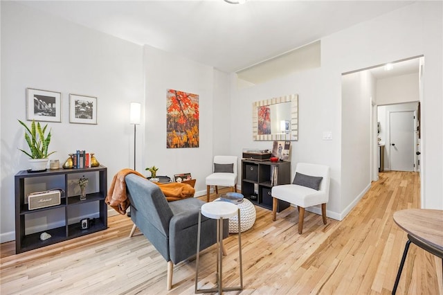 sitting room with light wood-type flooring and baseboards