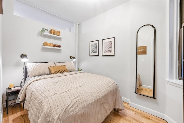 bedroom featuring light wood-type flooring and baseboards