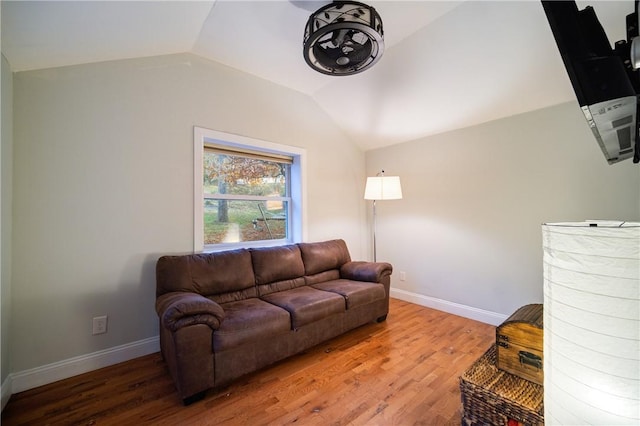 living room with wood-type flooring and vaulted ceiling