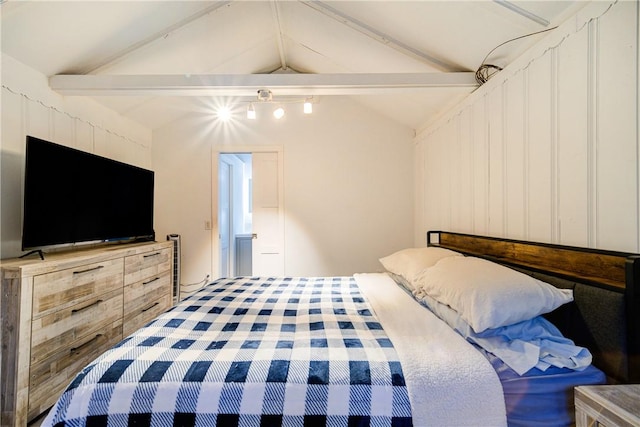 bedroom featuring vaulted ceiling with beams