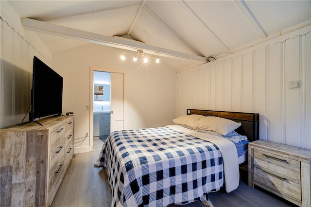 bedroom featuring ensuite bath, wooden walls, dark hardwood / wood-style flooring, and lofted ceiling with beams