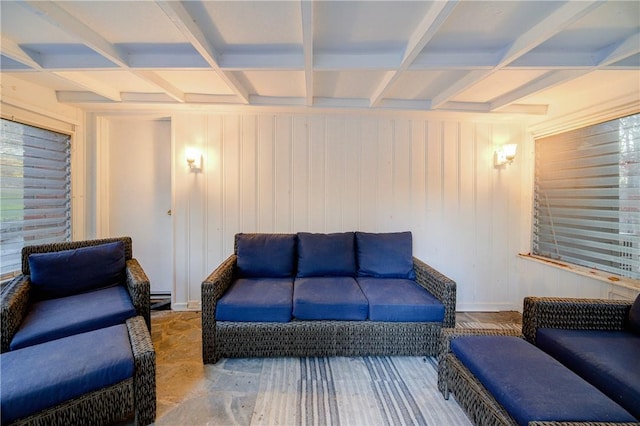 living room with beam ceiling and wood walls