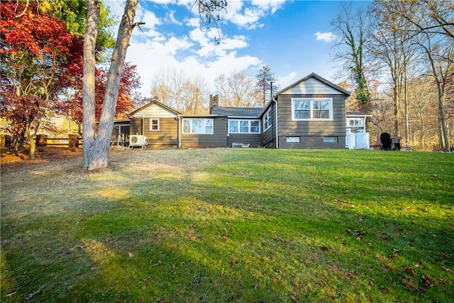 back of house with a lawn