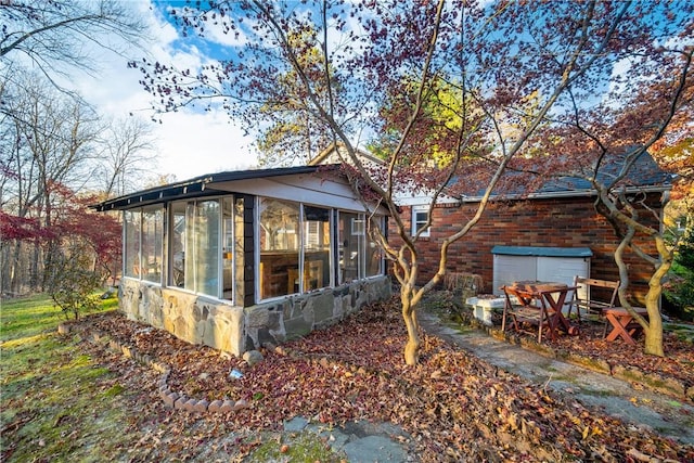 back of property with a sunroom