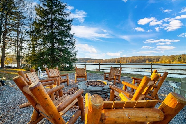 view of patio with a water view and an outdoor fire pit