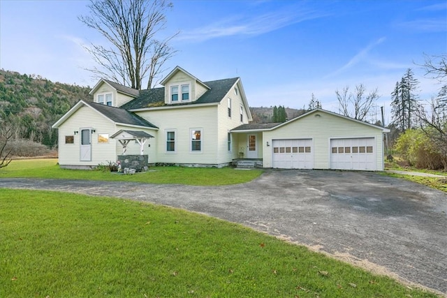 cape cod-style house with a garage and a front lawn