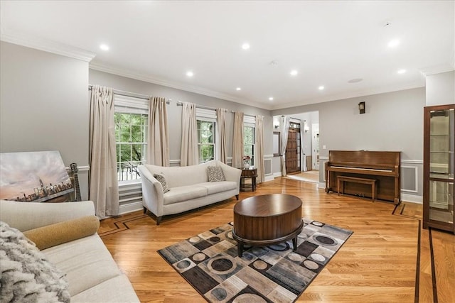 living room featuring light hardwood / wood-style floors and ornamental molding