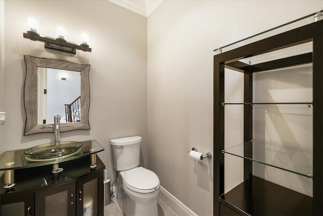 bathroom featuring vanity, toilet, and crown molding