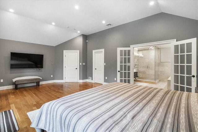 bedroom featuring ensuite bathroom, french doors, high vaulted ceiling, and light hardwood / wood-style floors