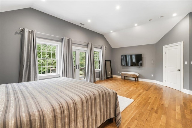 bedroom with light hardwood / wood-style floors and vaulted ceiling