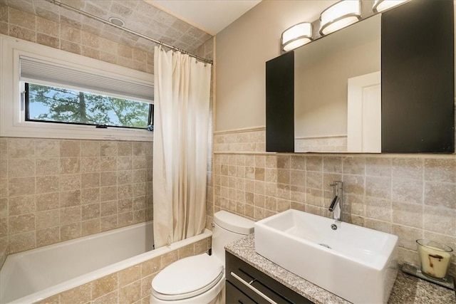 full bathroom featuring vanity, shower / bath combination with curtain, tile walls, and toilet