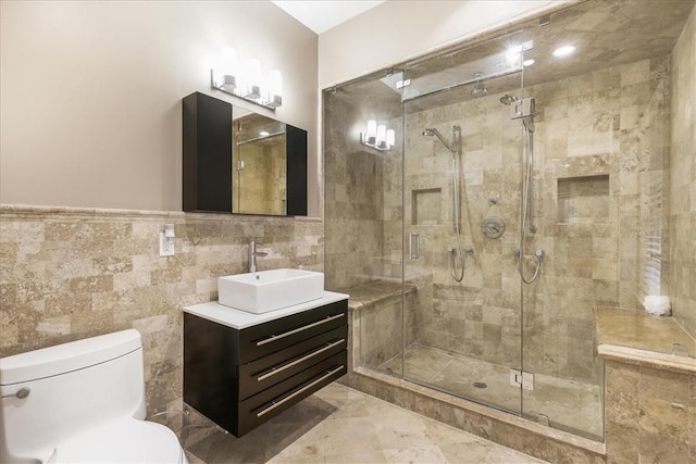 bathroom featuring walk in shower, vanity, tile walls, and toilet