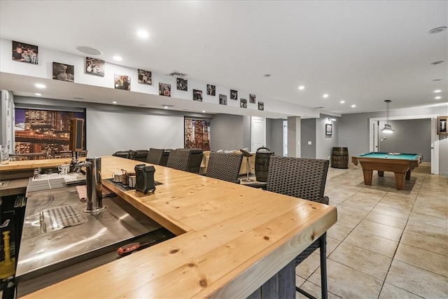 interior space featuring light tile patterned flooring, hanging light fixtures, and pool table