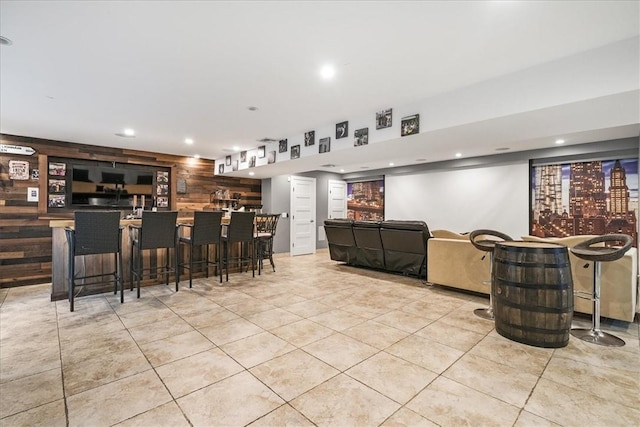 interior space featuring wooden walls and light tile patterned flooring