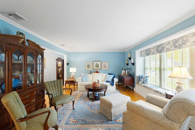 living room with crown molding, wood finished floors, and visible vents