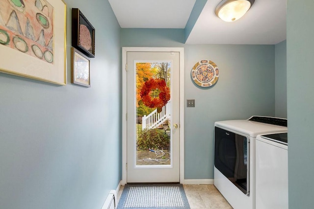 laundry area with laundry area, light tile patterned flooring, washing machine and dryer, and baseboards