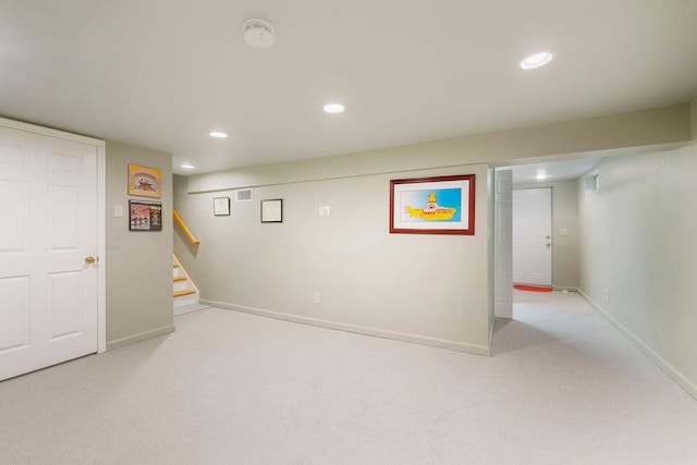 finished below grade area with stairway, recessed lighting, baseboards, and carpet floors