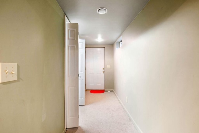 hall featuring carpet flooring and baseboards