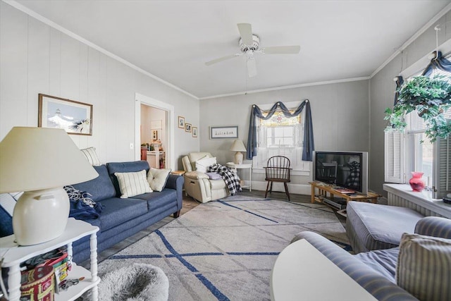 living room with ceiling fan and crown molding