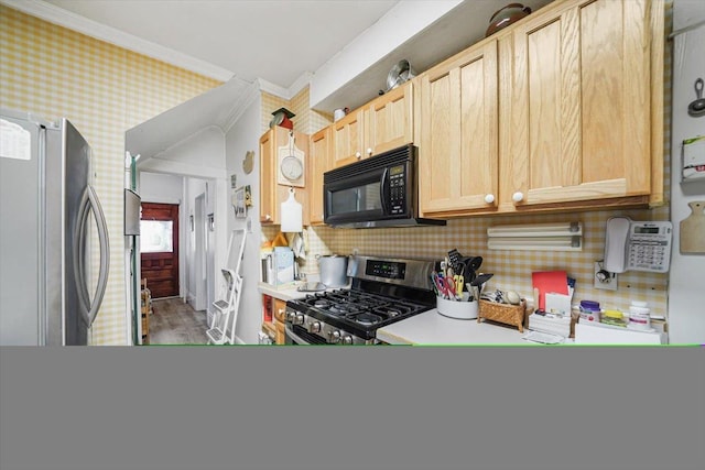 kitchen featuring crown molding, light brown cabinetry, wood-type flooring, and appliances with stainless steel finishes