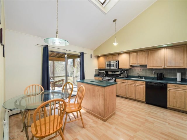 kitchen with decorative backsplash, appliances with stainless steel finishes, a skylight, decorative light fixtures, and high vaulted ceiling