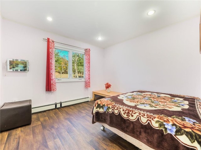 bedroom with dark hardwood / wood-style floors and a baseboard radiator