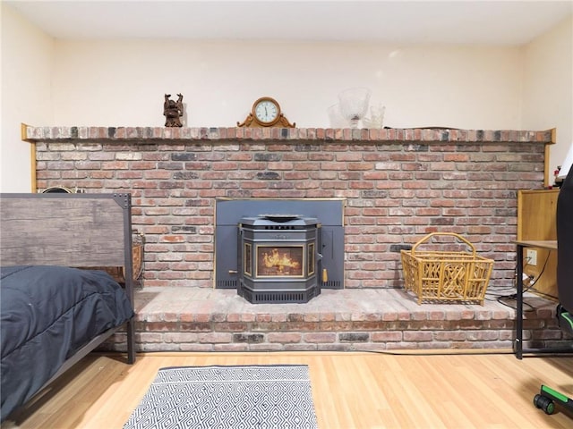 room details featuring hardwood / wood-style flooring and a wood stove