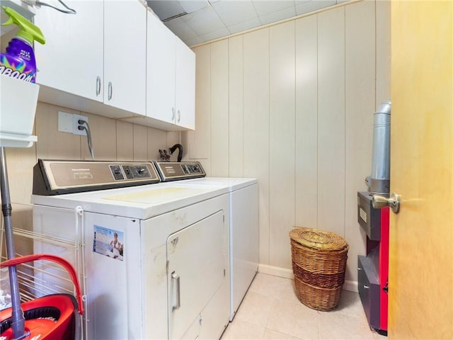 laundry room featuring light tile patterned floors, cabinets, and independent washer and dryer