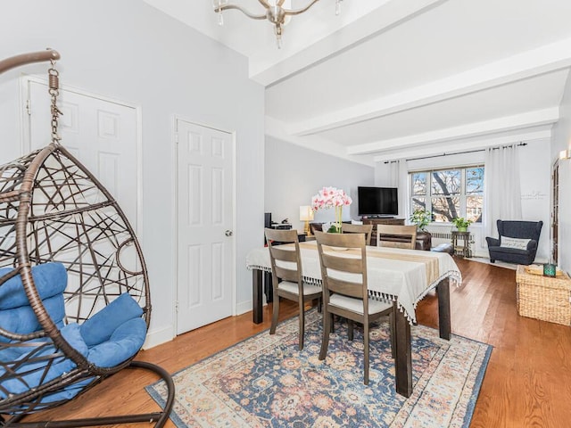 5601 Riverdale Ave Unit 1C, Bronx, NY 10471 - dining space with wood finished floors, beam ceiling, a chandelier, and baseboards