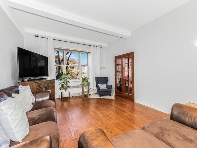 5601 Riverdale Ave Unit 1C, Bronx, NY 10471 - living room featuring wood finished floors, french doors, radiator, baseboards, and beamed ceiling