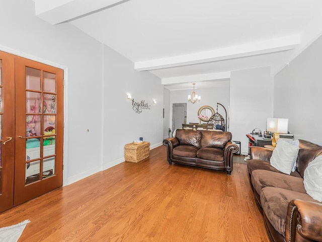 5601 Riverdale Ave Unit 1C, Bronx, NY 10471 - living room featuring a chandelier, beam ceiling, light wood-type flooring, and baseboards