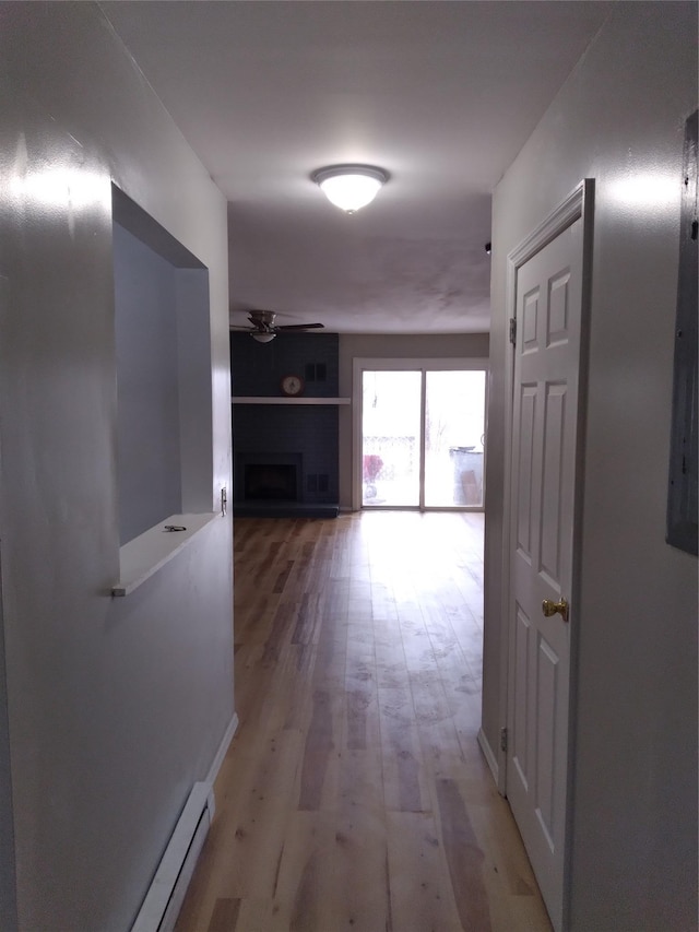 hallway with hardwood / wood-style floors