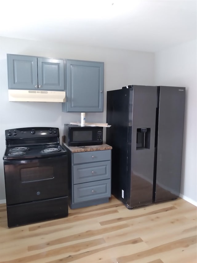 kitchen with light wood-type flooring and black appliances