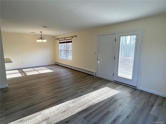 foyer entrance featuring a notable chandelier, dark hardwood / wood-style floors, and a baseboard radiator