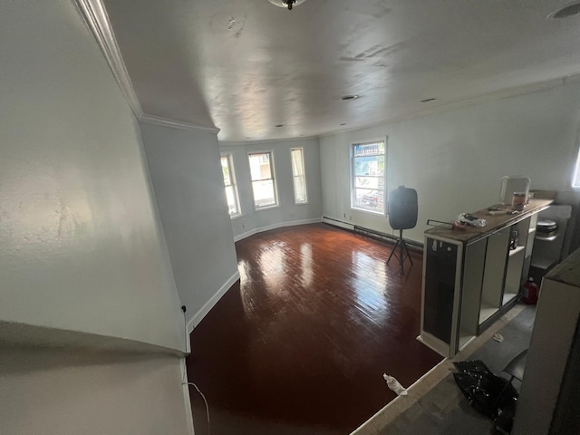 interior space with baseboard heating, crown molding, and dark hardwood / wood-style flooring