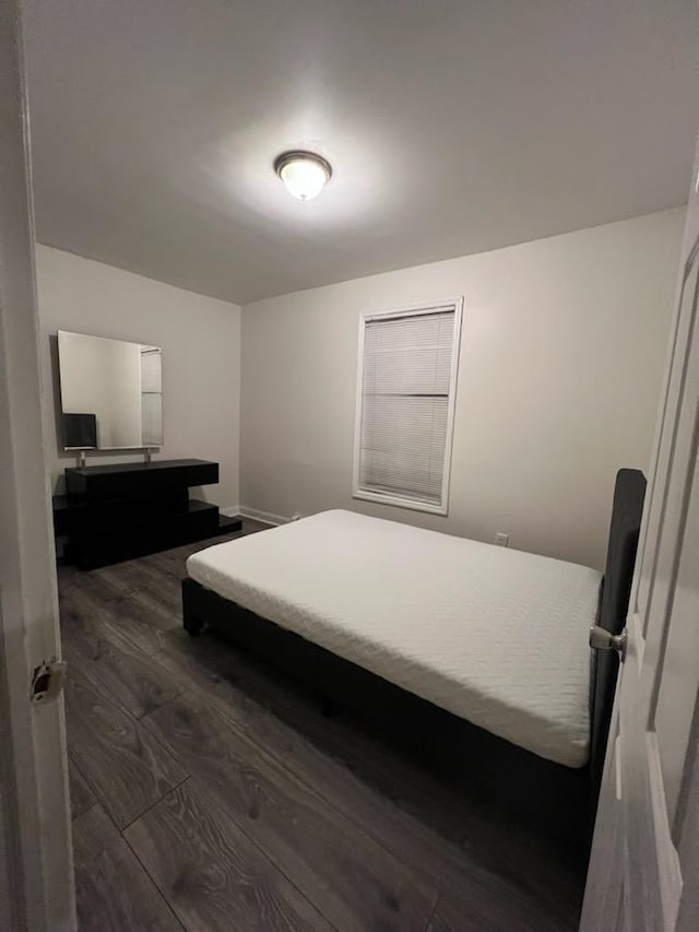 bedroom featuring dark wood-type flooring