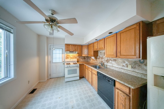 kitchen featuring plenty of natural light, ceiling fan, white appliances, and sink