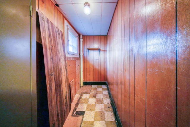 corridor featuring wood walls