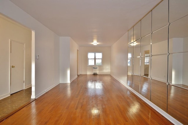 empty room with radiator and light hardwood / wood-style floors