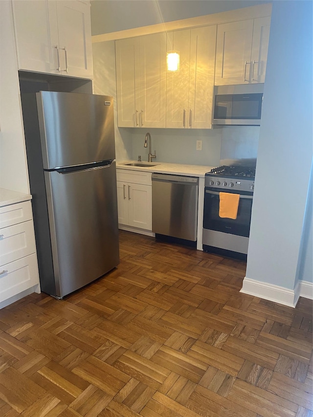 kitchen featuring white cabinets and parquet flooring