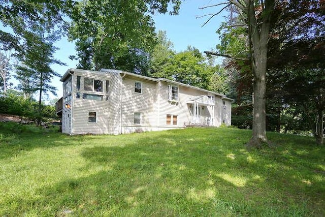 rear view of property with a yard